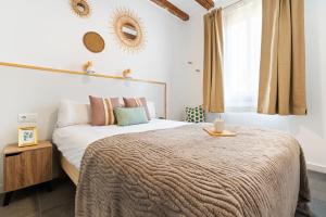 a bedroom with a large bed and a window at Lodging Apartments Almirall Beach 51 in Barcelona