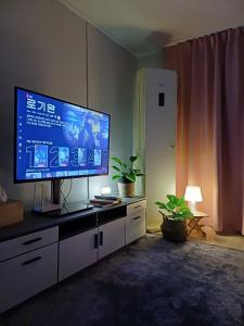 a living room with a large flat screen tv at With us2 #sillim station #seowon station #netflix #wifi in Seoul