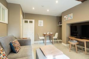 a living room with a couch and a table at Central 1 Bed with Free Private Parking and Sofa Bed in Cheltenham