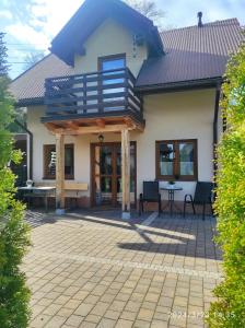 a house with a deck and a patio at Domek w górach in Sucha Beskidzka