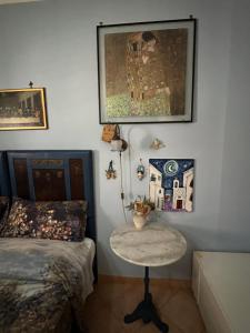 a bedroom with a bed and a table and a picture at Prospettiva Polignano in Polignano a Mare