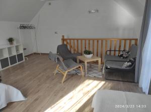 a living room with two chairs and a table at Domek w górach in Sucha Beskidzka