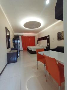 een kamer met een bed en een tafel en stoelen bij Pensao Martins in Maputo