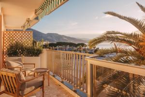 uma varanda com cadeiras e vista para o oceano em Soleil Riviera Apartament Côte d’Azur em Roquebrune-Cap-Martin