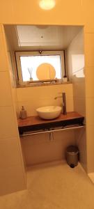 a bathroom with a sink and a mirror at Recanto da Neta in Seia