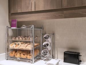 a display case full of donuts in a kitchen at Residence Inn by Marriott Jackson The District at Eastover in Jackson