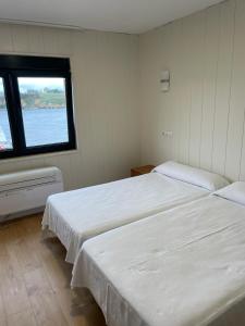 Posteľ alebo postele v izbe v ubytovaní Hotel Alda Fogar do Mariñeiro