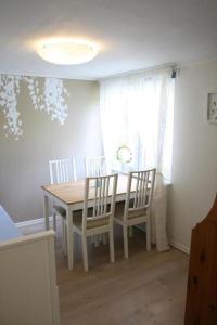 ein Esszimmer mit einem Tisch, Stühlen und einem Fenster in der Unterkunft Ferienwohnung Småland ausserhalb Älmhult in Diö
