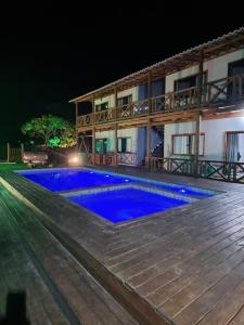 a villa with a swimming pool at night at Via Del Mare Flats in Marau
