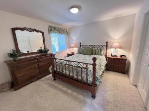 a bedroom with a bed and a mirror and a dresser at 555 Lancaster St. in Cambria