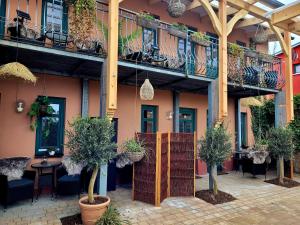 un bâtiment avec une terrasse agrémentée de plantes en pot dans l'établissement Pension Lavida Usedom, à Zinnowitz