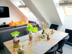 a dining room with a table with vases on it at Bienvenue dans l'ambre 2 à 7 couchages in Cholonge