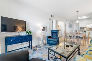 a living room with a blue couch and a table at Gulf Shores Plantation-East 3210 in Gulf Shores
