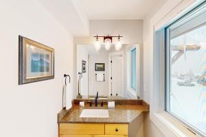 a bathroom with a sink and a large window at Saddle Ridge B2 in Big Sky +34 photos