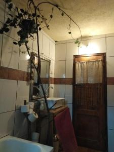 a bathroom with a sink and a wooden door at Shepherd's hut in nature in Vojnić