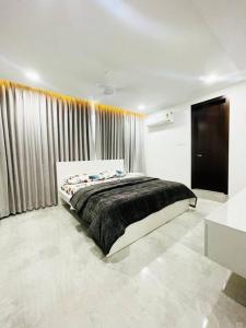 a bedroom with a bed and a large window at Dream Pent House in Hyderabad