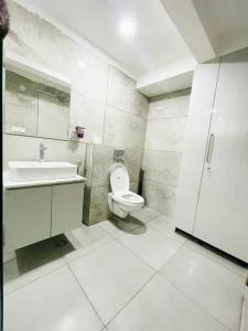 a bathroom with a toilet and a sink at Dream Pent House in Hyderabad
