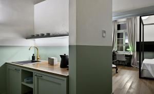 a kitchen with a sink and a counter top at Delightful Athens Apartment | 1 Bedroom Suite | Apartment Elexsion | Furnished Balcony with City View | Athinaidos in Athens