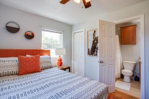 a bedroom with a bed and a toilet at Walkable OSU Apartment - 6 Blocks to Stadium! in Stillwater
