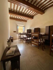 een woonkamer met een tafel en stoelen bij Ostello San Marco Cortona in Cortona