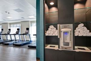 a gym with a row of treadmills and a row of donuts at Courtyard by Marriott Jackson Madison in Madison