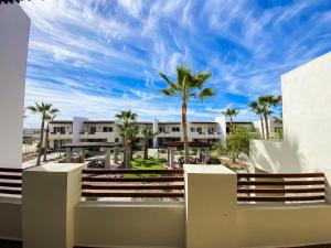 a view from the balcony of a resort with palm trees at New Built Condo minutes to Beach! in Puerto Peñasco