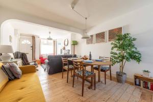 a living room with a table and a couch at Painter Cottage in Whitstable