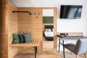 a room with a wooden wall with a bench and a table at Hotel Restaurant Sennerbad in Ravensburg