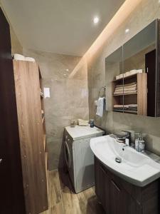 a bathroom with a sink and a washing machine at Charming 2-bed house in Kremasti in Kremasti