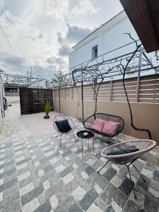 a patio with two chairs and a table and chairs at Charming 2-bed house in Kremasti in Kremasti