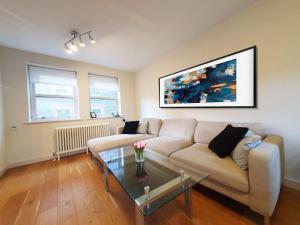 a living room with a couch and a table at Heart Of Soho : Covent Garden&Leicester Square in Croydon