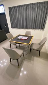 a table and chairs in a room with a window at 這一暫民宿 in Dongshan