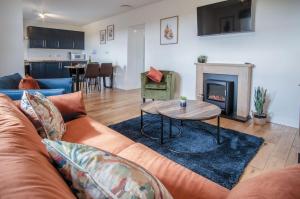 a living room with a couch and a fireplace at Anchor Well - 2 Bedroom Cottage - Ludchurch in Ludchurch