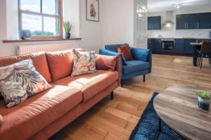 a living room with a couch and a table at Anchor Well - 2 Bedroom Cottage - Ludchurch in Ludchurch