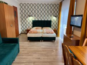 a bedroom with a bed and a flat screen tv at Baracuda in Dębki