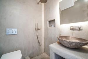 a bathroom with a bowl sink on a counter at Mykonian Exclusive 3Bd Villa with Private Pool in Panormos Mykonos