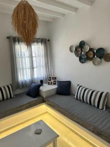 a living room with a couch and a table at Dreamy Island Escape in Naousa Paros in Naousa