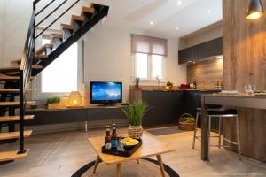 a living room with a staircase and a table at La Maison Blanche in Sangatte