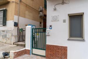a building with a gate in front of a building at B&b Anna's home in Marina di Camerota