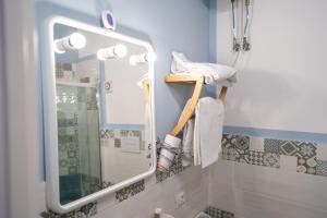 a bathroom with a mirror and a sink at B&b Anna's home in Marina di Camerota