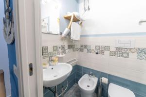 a bathroom with a sink and a toilet at B&b Anna's home in Marina di Camerota