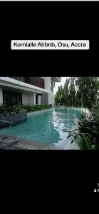 a picture of a swimming pool in front of a building at Kornialle in Accra