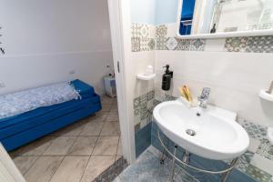 a bathroom with a sink and a bed at B&b Anna's home in Marina di Camerota