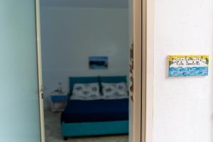 a bedroom with a bed and a door with a mirror at B&b Anna's home in Marina di Camerota