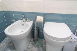 a bathroom with a toilet and a bidet at B&b Anna's home in Marina di Camerota