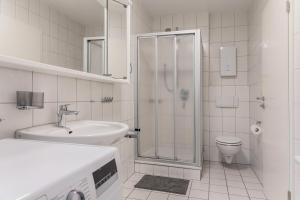 a bathroom with a shower and a sink and a toilet at 50180... in Harlesiel