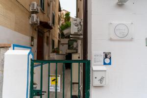 an alley with an open door in a building at B&b Anna's home in Marina di Camerota