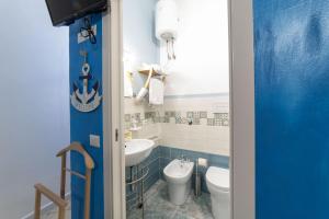 a bathroom with a toilet and a sink at B&b Anna's home in Marina di Camerota