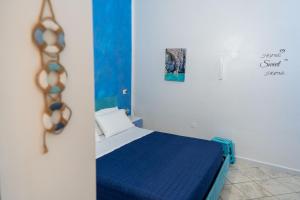 a small bedroom with a blue bed in a room at B&b Anna's home in Marina di Camerota