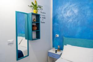 a bedroom with a mirror next to a bed at B&b Anna's home in Marina di Camerota